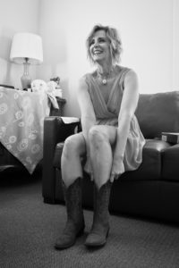 Singer songwriter Christine Rosander putting on boots for the filming of the Been A Long Time music video.