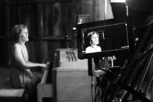 Singer songwriter Christine Rosander singing on set of the Been A Long Time music video.