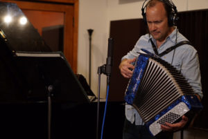 Doug Petty playing accordian at the studio.