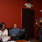 Christine Rosander working out tunes in the recording studio with band members.